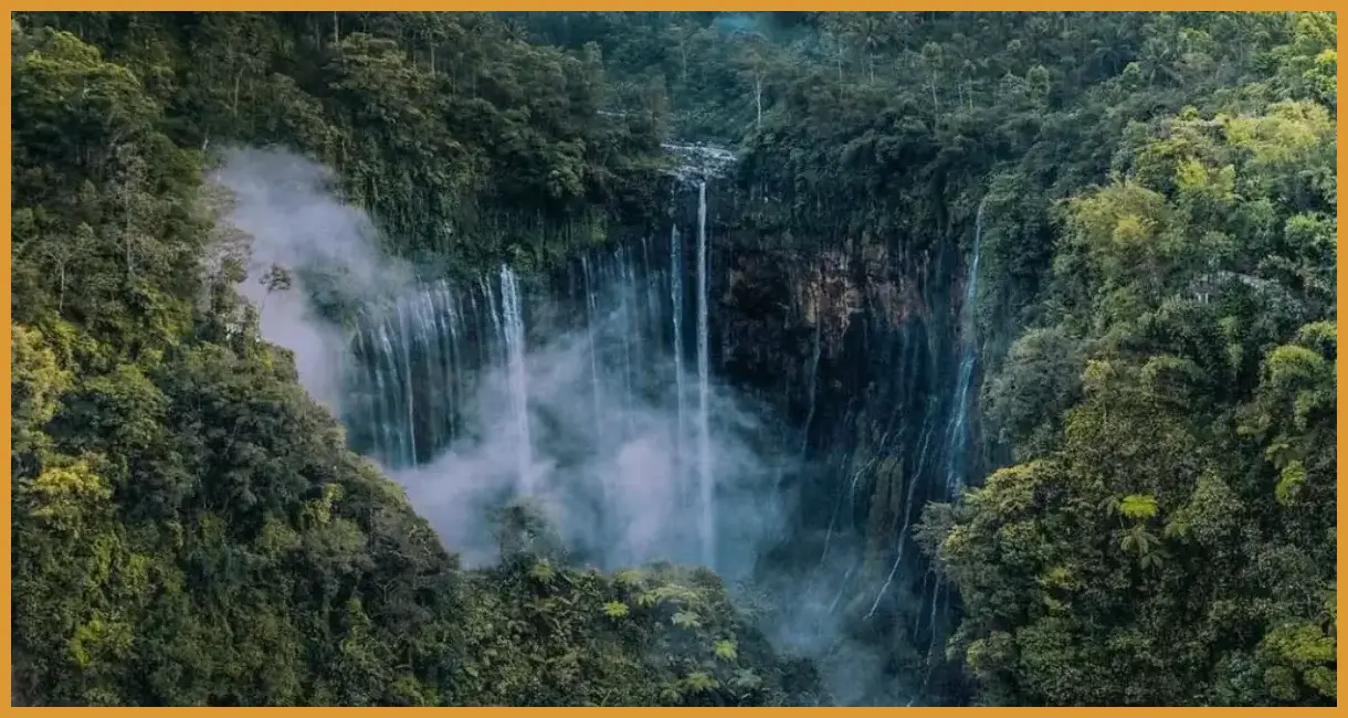 Ambil sudut low angle di gardu pandang Tumpak Sewu untuk menangkap keseluruhan lebar air terjun dengan latar puncak Semeru yang sering mengeluarkan asap tipis.